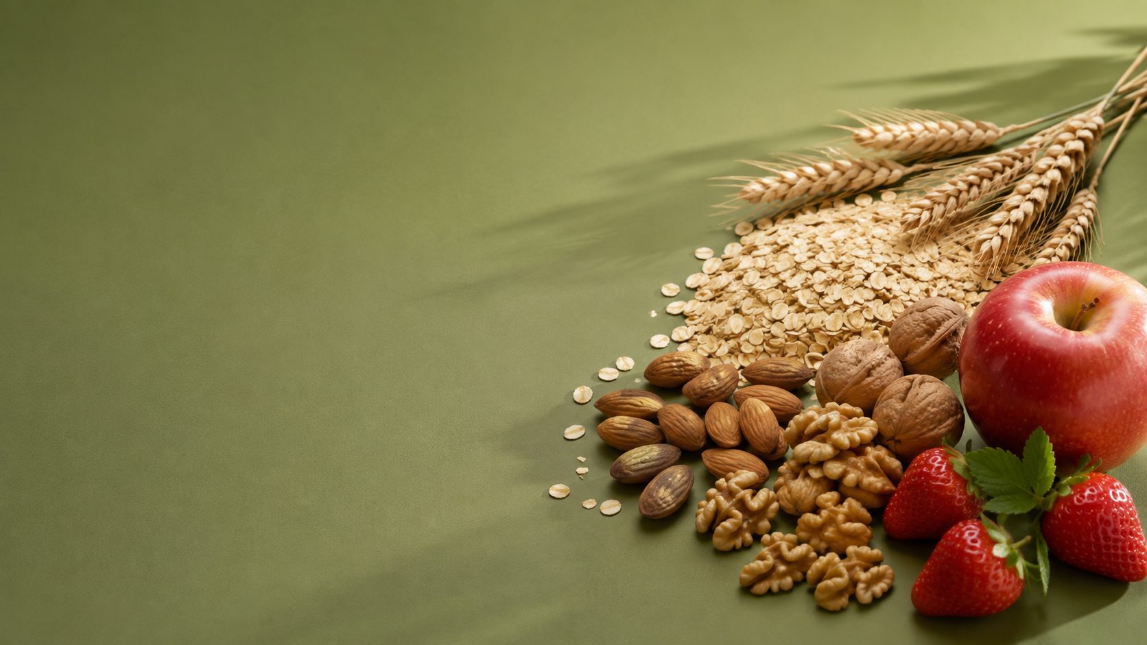 Avena, trigo, almendras, nueces y fruta fresca sobre fondo verde